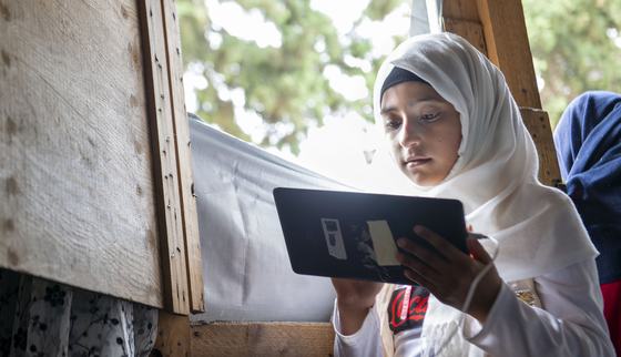 Girl Laila learns through tablet education in Lebanon_Can't Wait to Learn_War Child_200802
