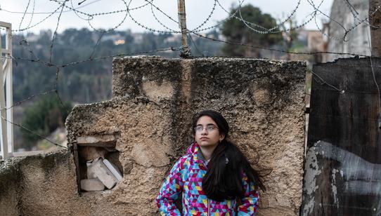 Girl standing in front of the gated walls_Hebron_OPT_War Child_191211