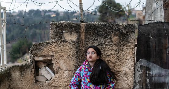 Girl standing in front of the gated walls_Hebron_OPT_War Child_191211